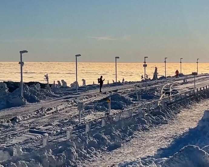 hikers-enjoy-early-morning-walk-in-snowy-landscape-in-the-harz-mountain-range-in-northern-germany