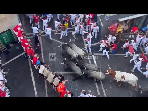 people-run-with-charging-bulls-at-pamplona’s-san-fermin-festival