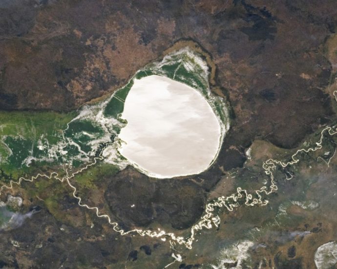 Lake-filled impact crater in Africa transforms into a giant silver ‘mirror’ via rare phenomenon — Earth from space