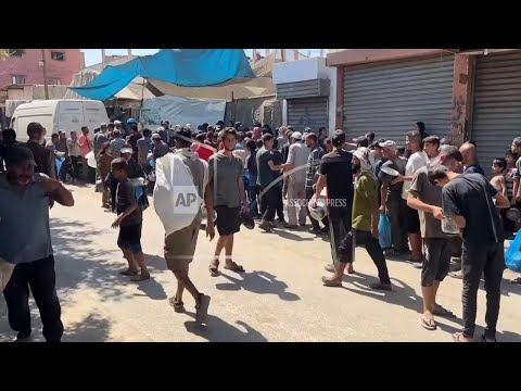dozens-of-palestinians-line-up-to-get-rice-from-a-charity-kitchen-in-central-gaza