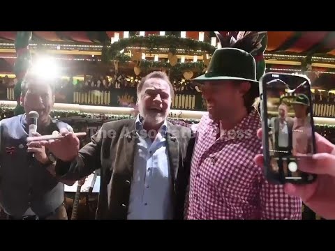 arnold-schwarzenegger-directs-a-band-in-a-beer-tent-at-munich’s-oktoberfest