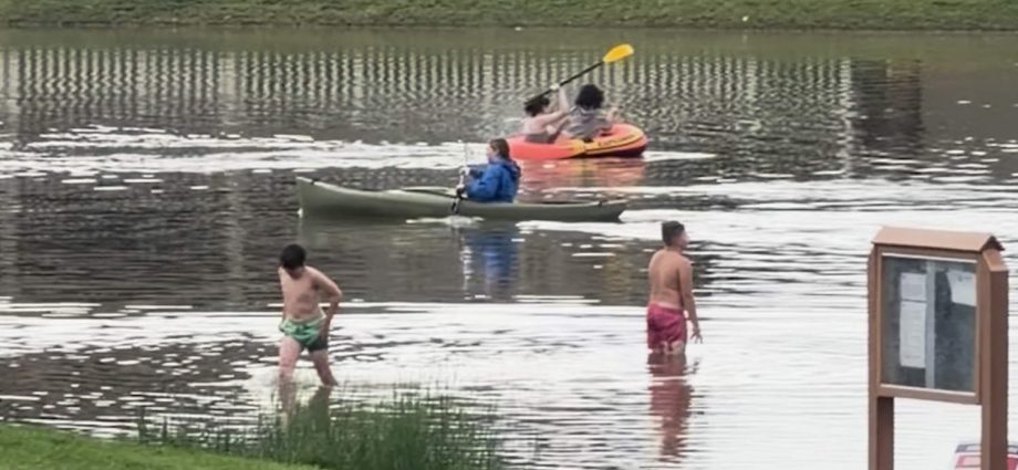several-people-canoe-in-flooded-utah-streets