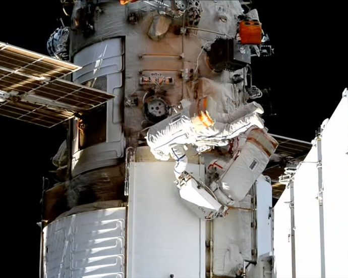 Spacewalking Russian cosmonauts install experiments on the International Space Station
