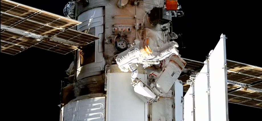 Spacewalking Russian cosmonauts install experiments on the International Space Station