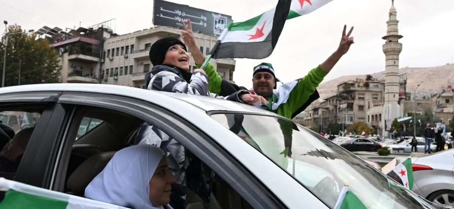 celebrations,-military-parade-mark-one-year-since-fall-of-assad