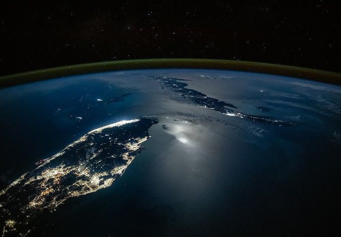 city-lights-glow-along-moonlit-waters