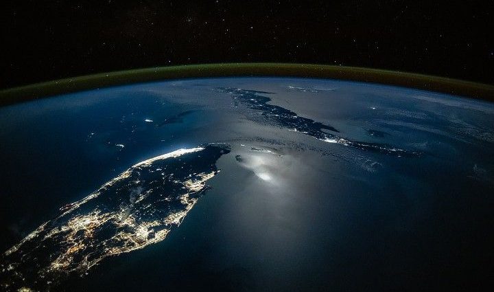 city-lights-glow-along-moonlit-waters