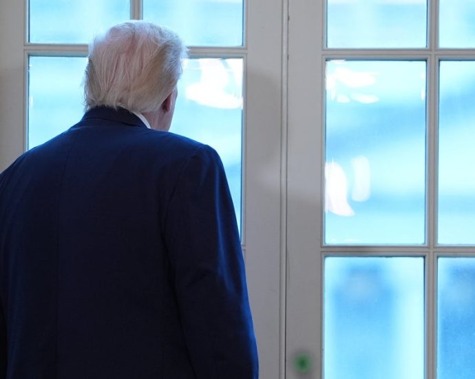 the-traitor-gets-up,-walks-away-from-meeting-to-stare-out-window-at-ballroom