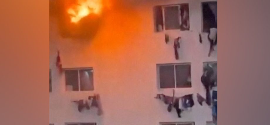 people-climb-from-windows-of-burning-campus-building-in-dakar
