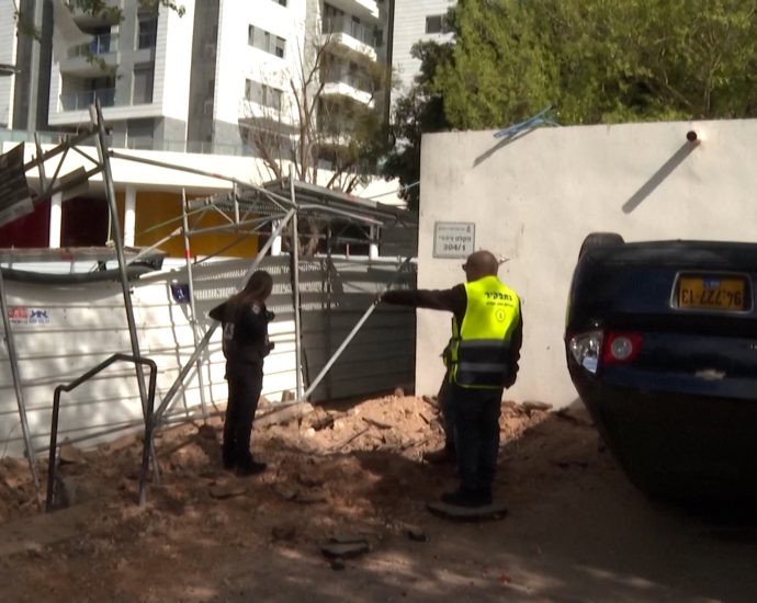 iranian-missile-strike-damages-cars-and-street-in-israel