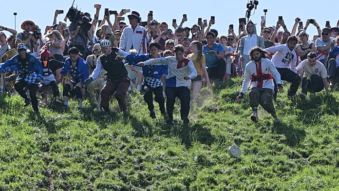 uk:-centuries-old-cheese-rolling-in-brockworth-attracts-crowds-from-across-europe