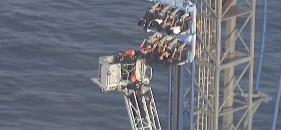 firefighters-work-to-free-riders-stuck-atop-a-rollercoaster-in-texas