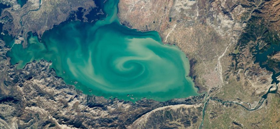 Giant, milky-green vortex swirls across massive ‘cryptodepression’ lake in Southern Europe — Earth from space