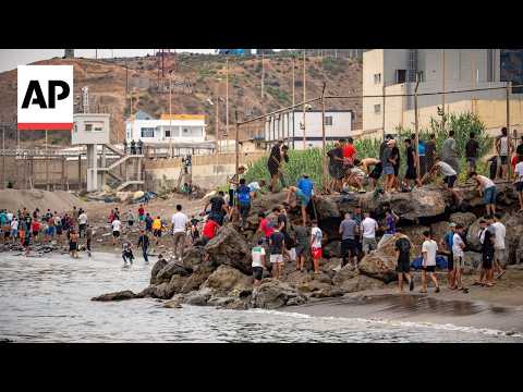people-at-ceuta-border-fence-as-migrants-try-to-reach-spanish-territory