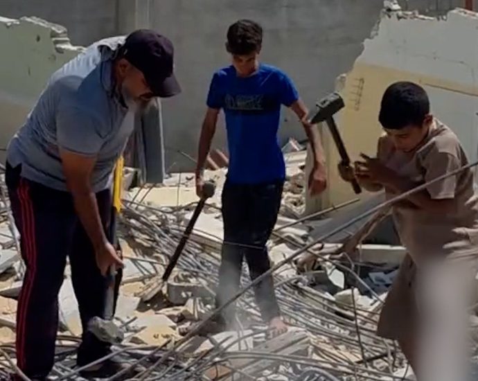 father-and-sons-forced-to-manually-clear-rubble-in-gaza
