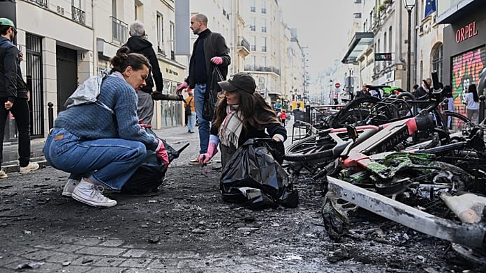burnt-bicycles,-smashed-windows-and-looted-shops:-trail-of-destruction-across-paris