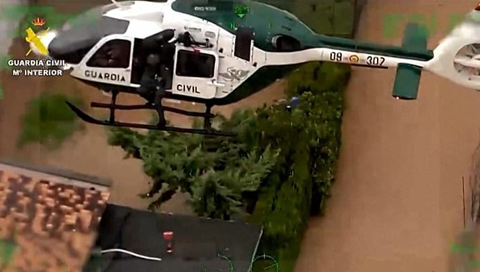 spain:-guardia-civil-rescues-family-and-dogs-from-rising-floodwaters-in-oliva