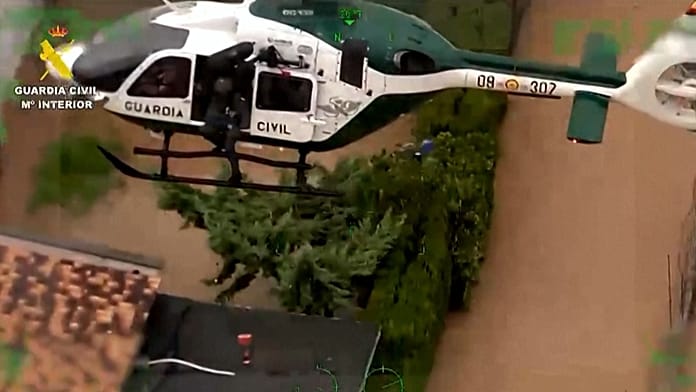 spain:-guardia-civil-rescues-family-and-dogs-from-rising-floodwaters-in-oliva